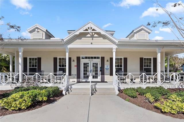 view of front of property featuring covered porch and french doors