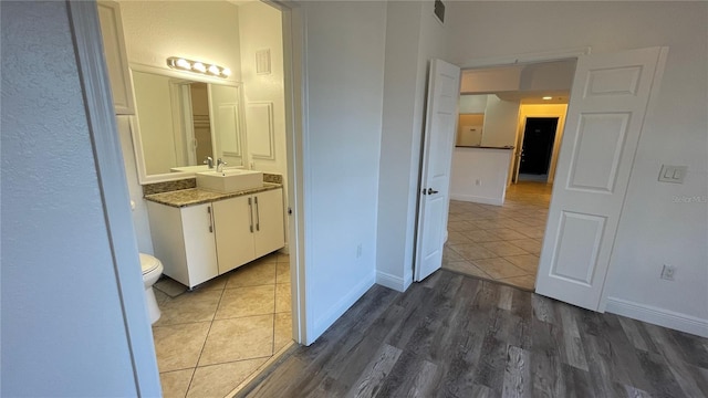 bathroom with vanity, hardwood / wood-style floors, and toilet