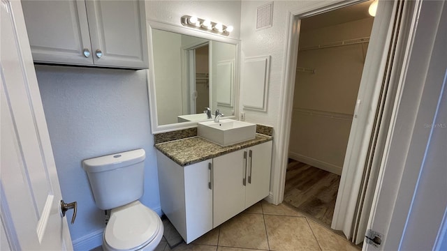 bathroom with vanity, tile patterned floors, and toilet