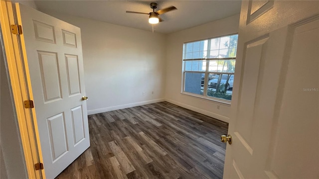 spare room featuring dark hardwood / wood-style flooring and ceiling fan