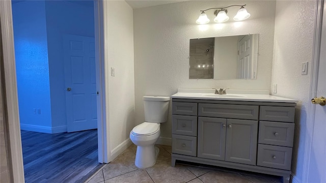 bathroom featuring vanity, toilet, and tile patterned flooring