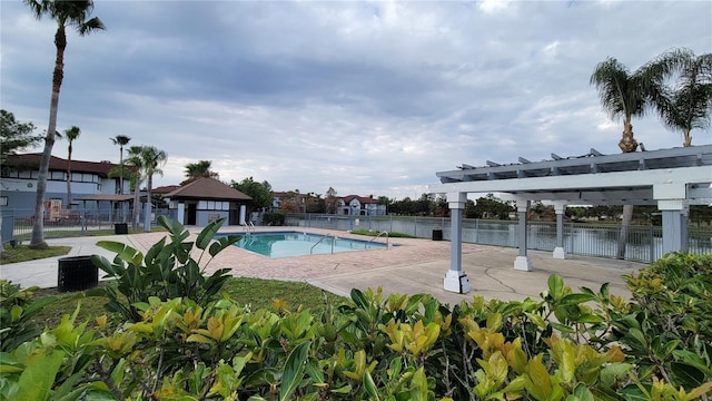 view of swimming pool with a pergola, a patio area, a gazebo, and a water view