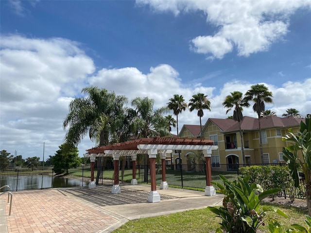 surrounding community featuring a pergola and a water view