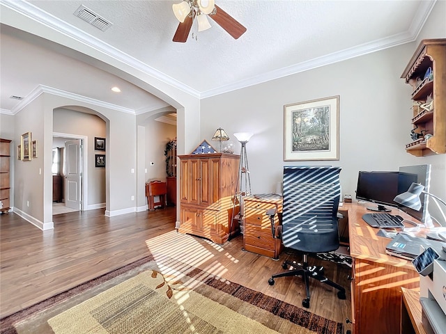 home office with hardwood / wood-style flooring, crown molding, a textured ceiling, and ceiling fan