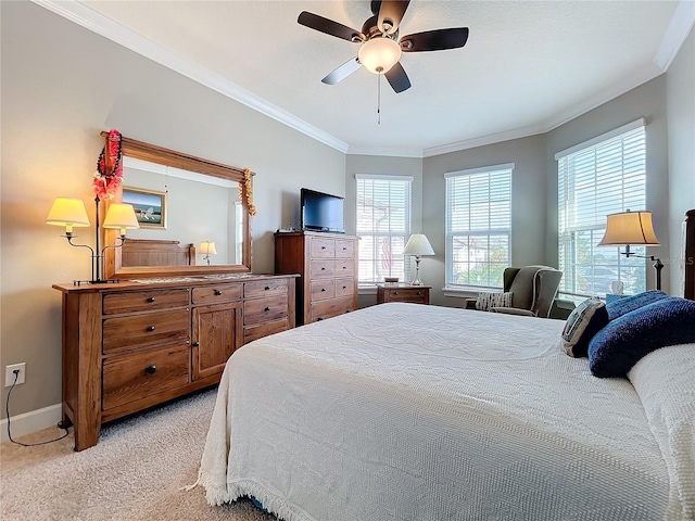 bedroom featuring crown molding, light colored carpet, and ceiling fan