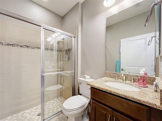 bathroom with vanity, toilet, and walk in shower