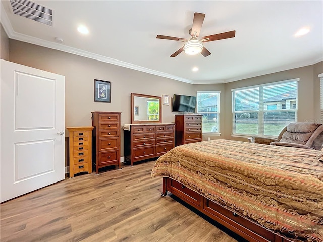 bedroom featuring crown molding, ceiling fan, and light hardwood / wood-style floors