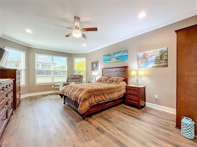 bedroom with ceiling fan, ornamental molding, hardwood / wood-style floors, and multiple windows