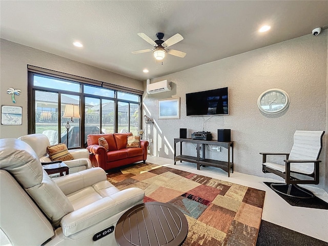 living room with a wall mounted AC, a textured ceiling, and ceiling fan