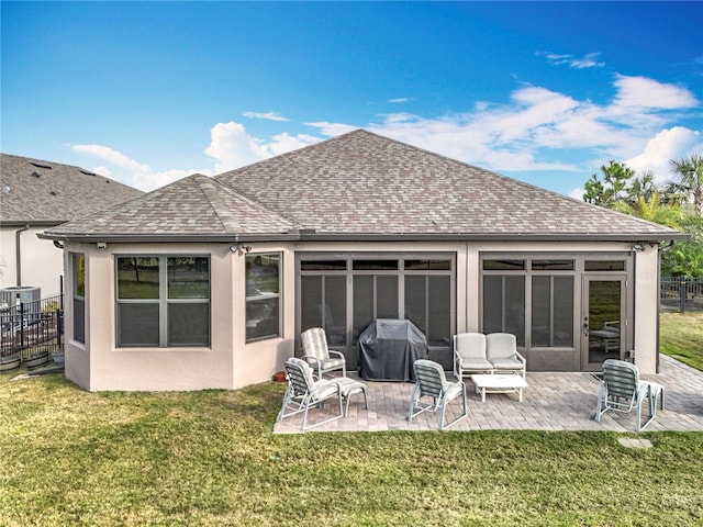 back of property featuring a lawn and a patio