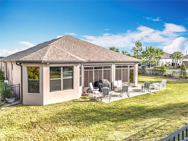 back of house with a sunroom, a patio, and a lawn