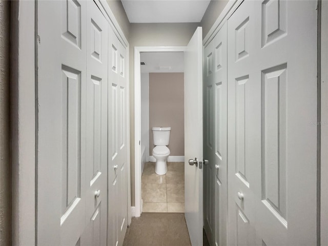 corridor with dark tile patterned flooring