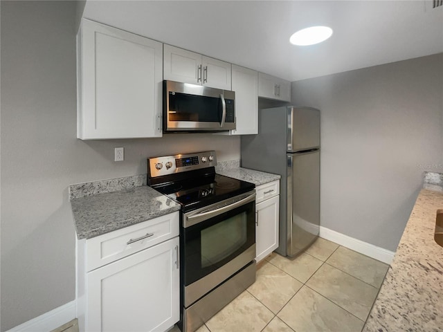 kitchen featuring light stone counters, white cabinets, and appliances with stainless steel finishes