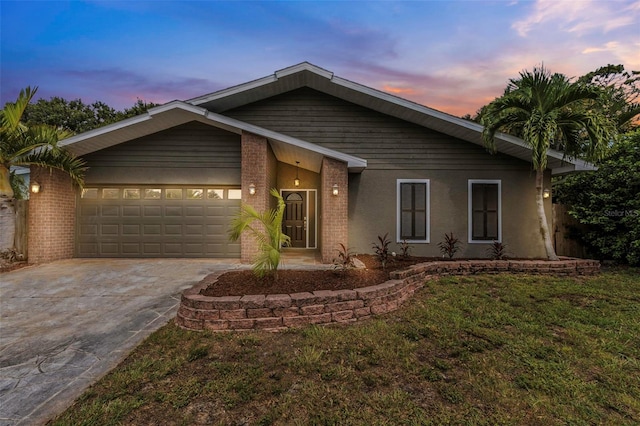 view of front of house featuring a garage and a lawn