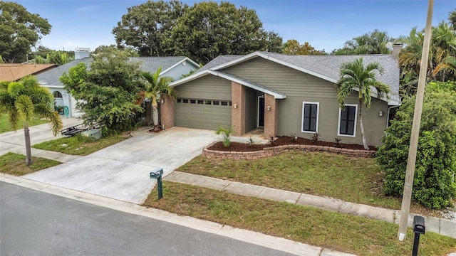 ranch-style home featuring a garage and a front yard