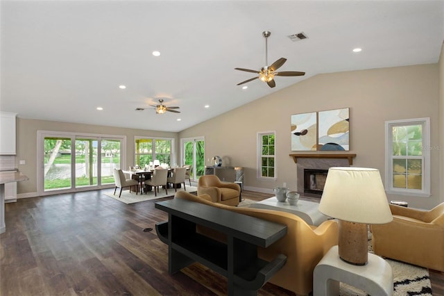 living room with lofted ceiling, dark hardwood / wood-style floors, and ceiling fan