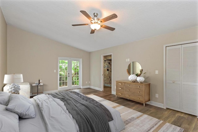 bedroom featuring dark hardwood / wood-style floors, lofted ceiling, ceiling fan, a textured ceiling, and french doors