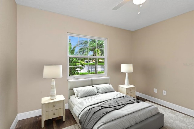 bedroom with dark wood-type flooring and ceiling fan