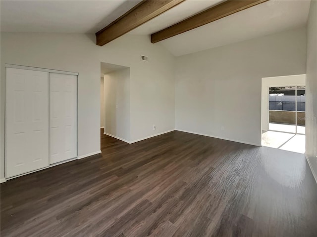 interior space featuring dark hardwood / wood-style flooring and lofted ceiling with beams