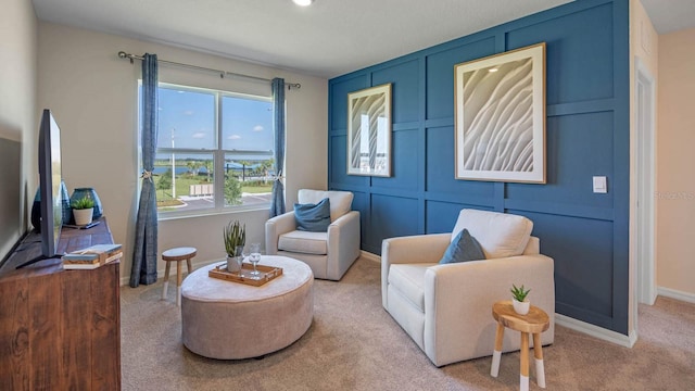 sitting room featuring light colored carpet