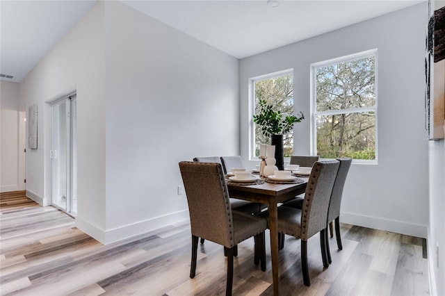 dining space with light hardwood / wood-style flooring