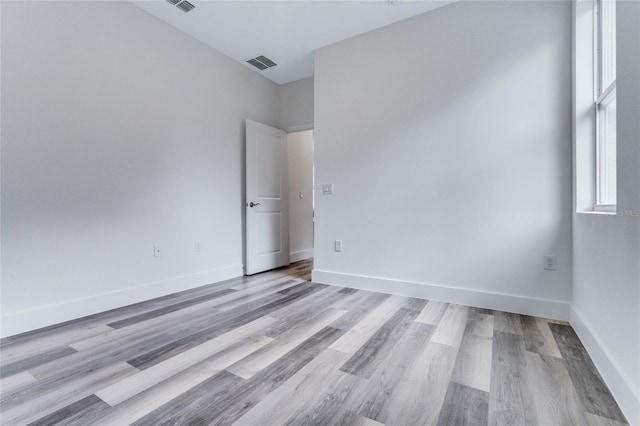 empty room with light hardwood / wood-style flooring