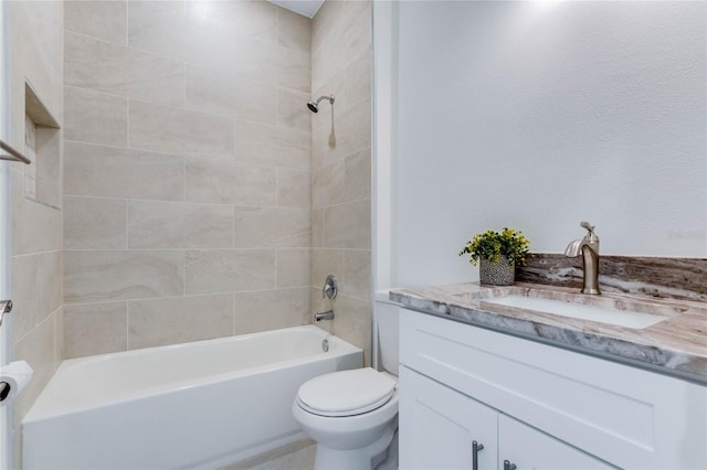 full bathroom with vanity, tiled shower / bath combo, and toilet