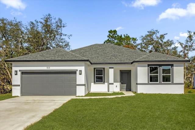 view of front of home featuring a garage and a front yard