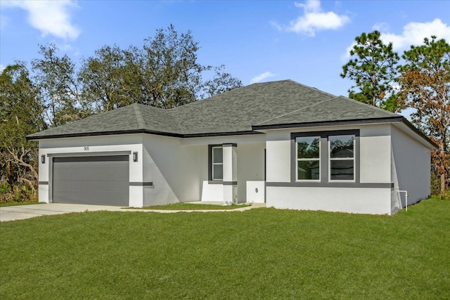 view of front of property with a garage and a front lawn