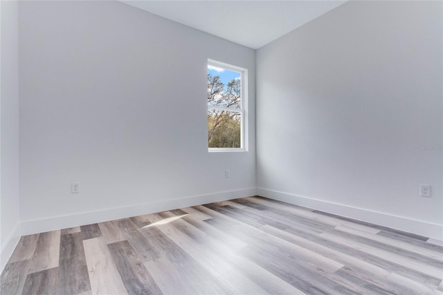 unfurnished room with light wood-type flooring