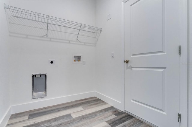 clothes washing area featuring washer hookup, hookup for an electric dryer, and light wood-type flooring