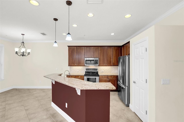 kitchen with a breakfast bar area, decorative light fixtures, a center island with sink, stainless steel appliances, and decorative backsplash