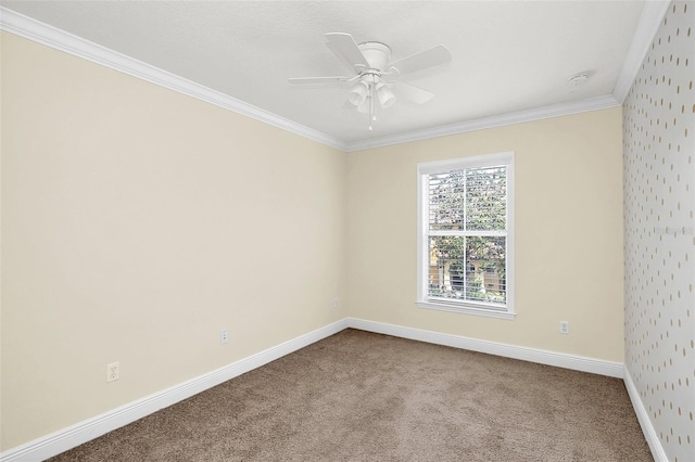 empty room featuring crown molding, ceiling fan, and carpet