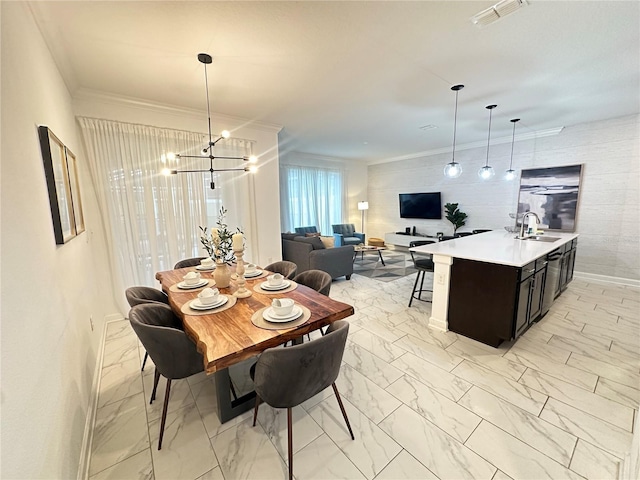 dining area with an inviting chandelier, sink, and ornamental molding