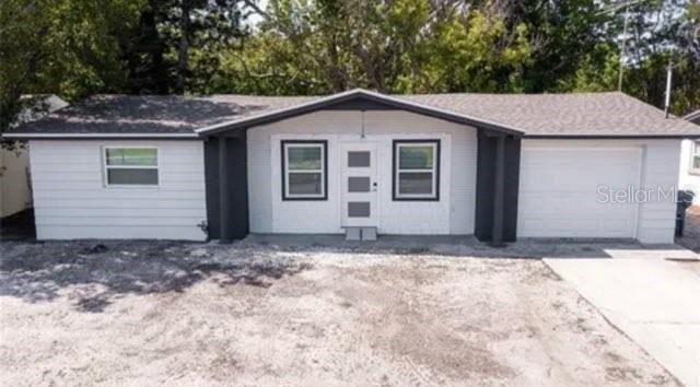 exterior space with a garage and concrete driveway