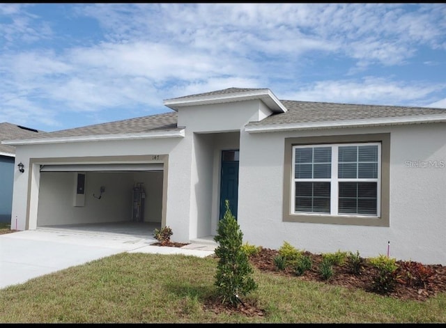 view of front of property featuring a garage and a front lawn