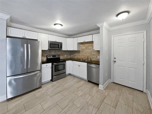 kitchen with white cabinetry, tasteful backsplash, ornamental molding, and appliances with stainless steel finishes