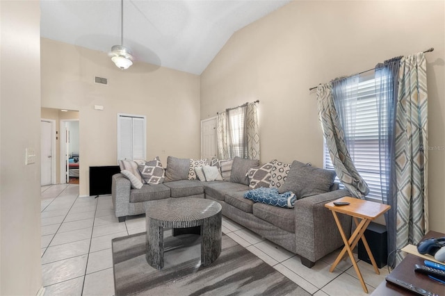 living room featuring light tile patterned flooring, ceiling fan, a healthy amount of sunlight, and high vaulted ceiling