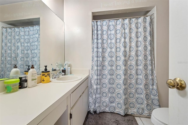 bathroom with vanity, toilet, and tile patterned flooring