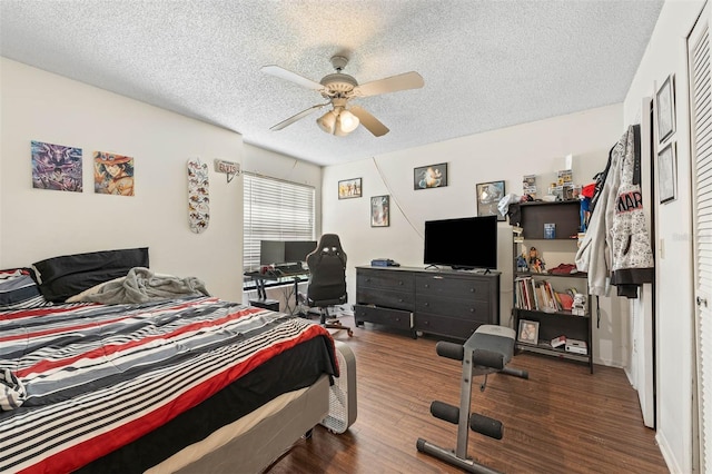 bedroom with ceiling fan, dark hardwood / wood-style floors, and a textured ceiling