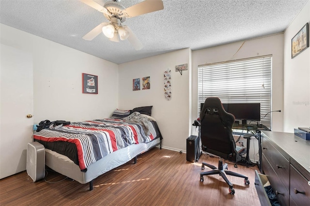 bedroom featuring hardwood / wood-style flooring, a textured ceiling, and ceiling fan