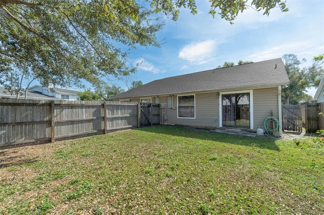 back of property featuring a yard