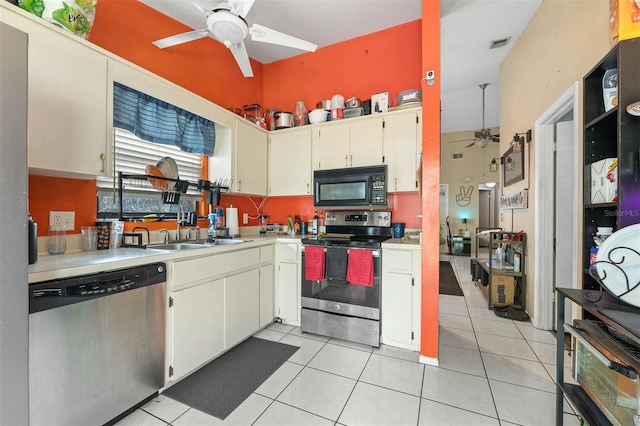 kitchen with sink, light tile patterned floors, ceiling fan, and appliances with stainless steel finishes