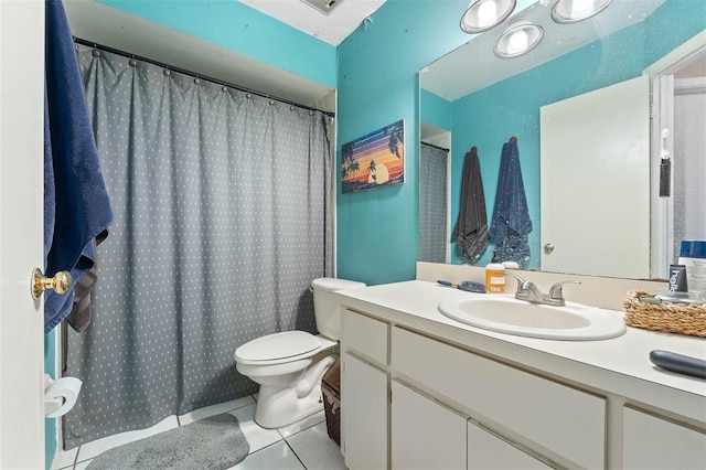 bathroom featuring vanity, tile patterned floors, and toilet