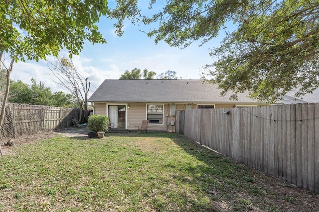 back of property featuring a yard