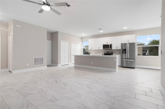 kitchen with sink, white cabinetry, a center island, ceiling fan, and stainless steel appliances