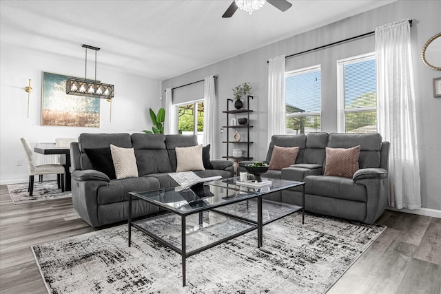 living room featuring hardwood / wood-style flooring and ceiling fan