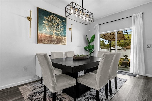 dining area with dark hardwood / wood-style floors