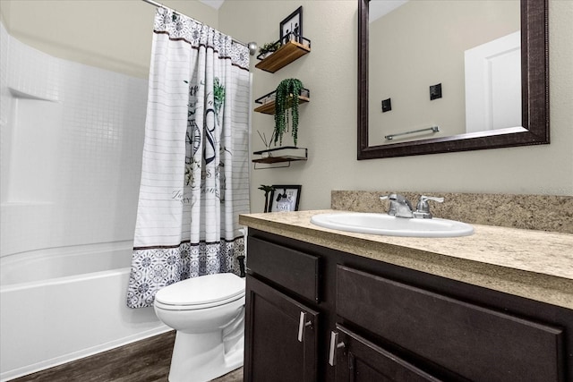 full bathroom featuring vanity, wood-type flooring, shower / bath combination with curtain, and toilet