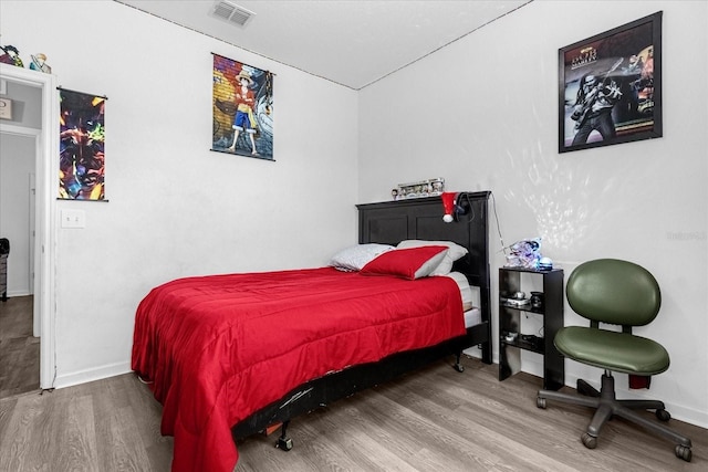 bedroom with hardwood / wood-style flooring